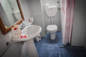 a bathroom with a sink and a toilet and a mirror at Casa Giuliana in Lipari