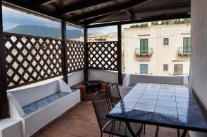 a balcony with a table and chairs and a view of a building at Casa Giuliana in Lipari