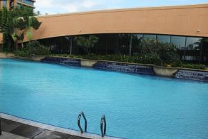 a large swimming pool in front of a building at FnF Suite @ Time Square in Kuala Lumpur