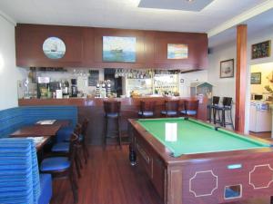 a bar with a pool table in a restaurant at Ker Annick in Saint Malo