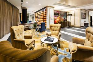 a lobby of a hotel with chairs and a table at The Tennessean Personal Luxury Hotel in Knoxville