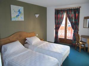 Voodi või voodid majutusasutuse Hotel Les Bruyères toas
