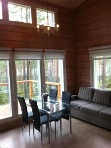 a living room with a table and a couch at Pyhäjärven Lomakylä in Ruolahti