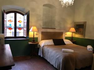 Ένα ή περισσότερα κρεβάτια σε δωμάτιο στο Osteria Del Vicario