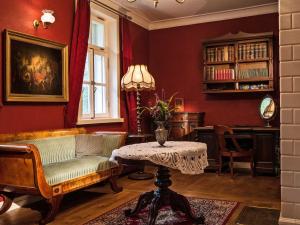 a living room with a couch and a table at Apartamenty Carskie in Białowieża