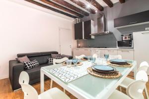 a kitchen and living room with a table and a couch at Arsenale Design Apartment R&R in Venice