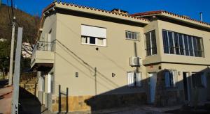 a large white house with a window on the side of it at Casacerro in Salta