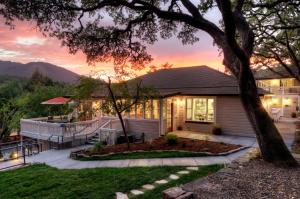 a house with a sunset in the background at Olea Hotel in Glen Ellen