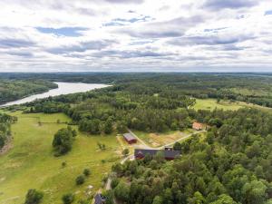 an aerial view of a house on a hill next to a river at Three Bedroom Farm Cottage Lake Access and Free Boat in Valdemarsvik