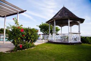 a gazebo with a table and chairs in a yard at Sol Mar Villa in Duncans