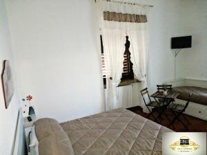 a bedroom with a bed and a couch and a window at Villa Antinea in Avellino