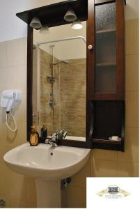 a bathroom with a sink and a glass shower at Villa Antinea in Avellino +15 photos