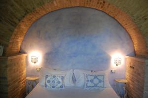 מיטה או מיטות בחדר ב-B&B Vento di Rose