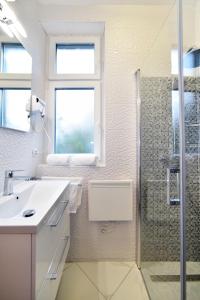 a bathroom with a sink and a shower at Apartment Sermazi in Zagreb