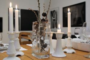 a table with candles and a vase with flowers in it at Dom Nałęczowski in Nałęczów