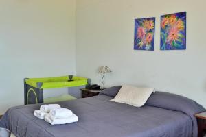 a bedroom with a bed with towels on it at Aguas del Monte Hotel SPA in San Miguel del Monte