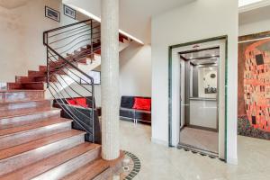 a spiral staircase in a living room with a couch at Hotel Villa Boschetti in San Mauro a Mare