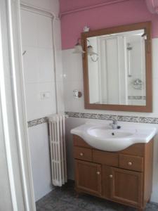 a bathroom with a sink and a mirror at Hostal Porta De Núria in Ribes de Freser