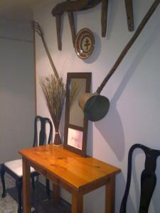 a wooden table with a vase on top of it at Hostal Porta De Núria in Ribes de Freser