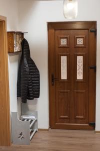 a coat hanging on a wall next to a door at Casa Gozna in Văliug