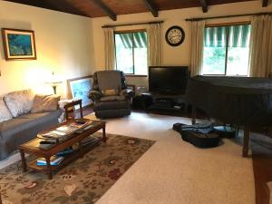 a living room with a couch and a table at Hale Maluhia Country Inn in Kailua-Kona