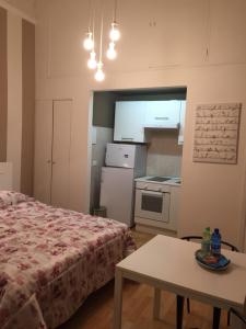 a bedroom with a bed and a table and a kitchen at Polo Residence in Florence