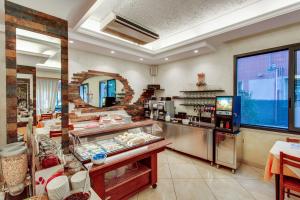a large kitchen with a counter with food in it at Hotel Villa Boschetti in San Mauro a Mare