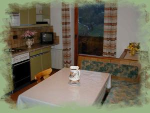a kitchen with a table with a coffee cup on it at Apartments Jäger in Trins +21 photos