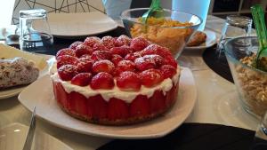 a strawberry cake on a plate on a table at B&B Sbarco dei 1000 in Marsala