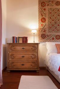 a bedroom with a dresser with a lamp on it at COLVAGO CIMA DODICI – DOLOMITES NATIONAL PARK in Santa Giustina