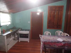 a kitchen with a table and a table and a dining room at pousada ferreira's in Paranapiacaba
