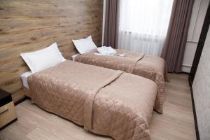 Postelja oz. postelje v sobi nastanitve Lumarc Hotel