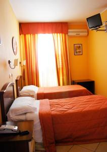 Postel nebo postele na pokoji v ubytování Greta Rooms Hotel
