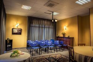 a meeting room with blue chairs and a table at Greta Rooms Hotel in Mazara del Vallo