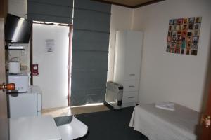 a small room with a bed and a television at Mount Barker Valley Views Motel & Chalets, Western Australia in Mount Barker