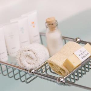 a metal basket with towels and a bottle of soap at Bernardus Lodge & Spa in Carmel Valley