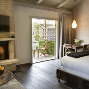 a bedroom with a bed and a patio with a table at Bernardus Lodge & Spa in Carmel Valley