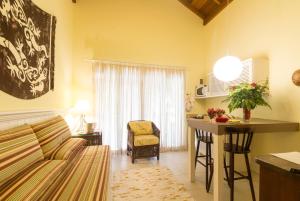 a living room with a couch and a table at Pousada Vila do Bosque in Bombinhas +137 photos