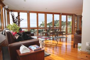 a living room with a couch and a table at Sails Ashore Lodge in Half-moon Bay