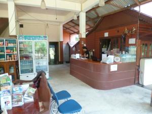 a store with a counter and a chair in front of it at Haad Salad Resort in Salad Beach