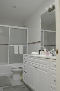 a white bathroom with a sink and a toilet at Waterway in Charleston +35 photos