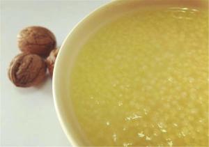 a bowl of green soup with hazelnuts on a table at 7Days Inn Tianjin Weishan Road in Tianjin