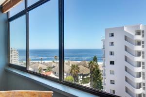 a room with a view of the ocean and a building at Backup-Powered Bantry Bay View 2 Bed Apartment in Cape Town