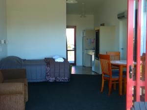 a living room filled with furniture next to a doorway at Beachview Motel Beachview Motel in Greymouth