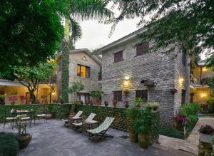 a building with chairs and tables in a courtyard at Mum's Garden Resort in Pokhara