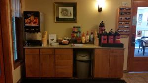 a counter in a room with bottles of wine at FairBridge Inn & Suites in Leavenworth