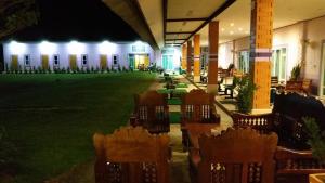 a row of chairs in a courtyard at night at Three Bays Resort in Prachuap Khiri Khan