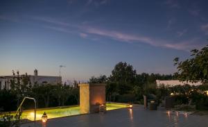 a backyard with a swimming pool at night at Hotel Al Mulino in Anacapri