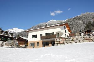 a building on top of a snow covered mountain at Appart Stefanie in Sankt Gallenkirch