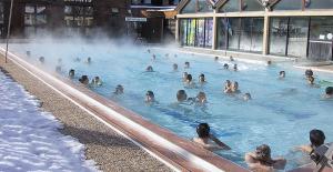 a group of people swimming in a heated swimming pool at Plagne Bellecote Apartments in Plagne Bellecote